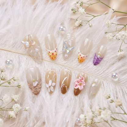Decorative press on nails with flowers and gemstones on a soft white background