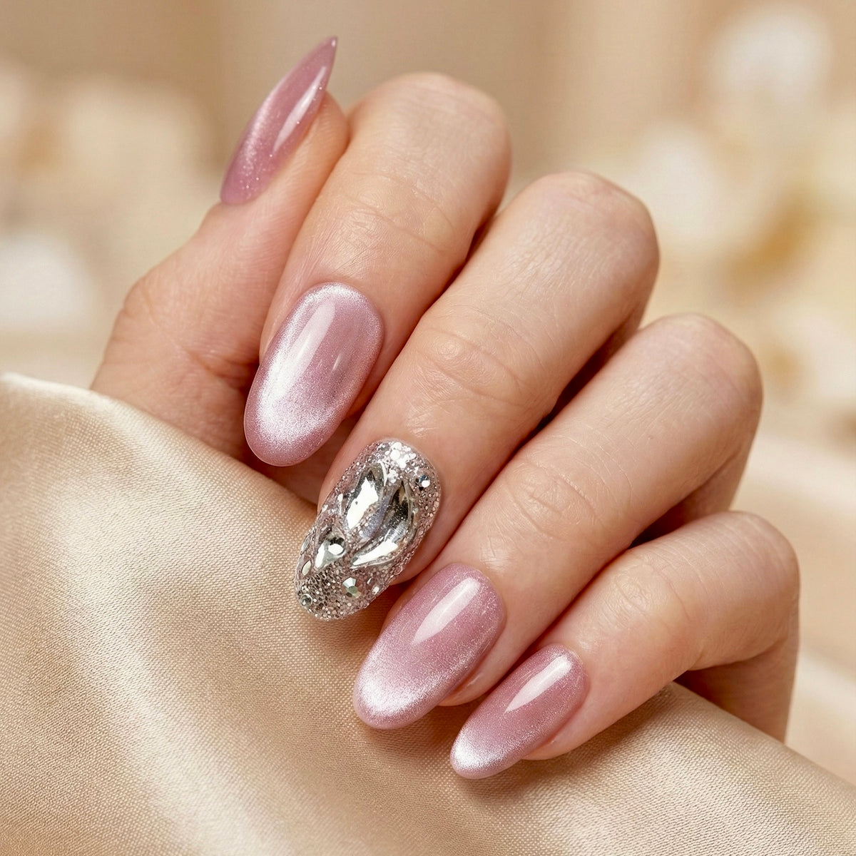 Hand with  Stardust press on nails on a beige fabric background