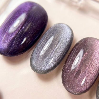 Makro-nærbilde av Lavender Haze løsnegler — multichrome cat-eye som skifter mellom lilla og sølv.